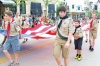 Boy Scouts marching up Franklin Street.